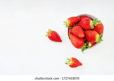 Fresh juicy strawberries in the bowl isolated over white background. Top view. Copy space - Powered by Shutterstock