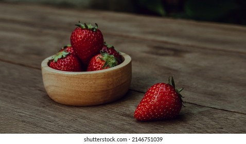Fresh juicy strawberries on natural wooden background. Tochiotome Japanese strawberry.