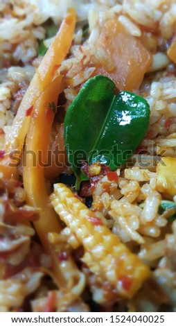 Fresh Kaffir lime leaves in chilli fried rice in Thai food.  The leaves has health benefits and useful such as stress reduction , promote sleep , improves oral healrh and pain relief Stock photo © 