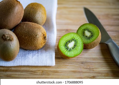 Fresh Kiwifruit On Wooden Cutting Board.