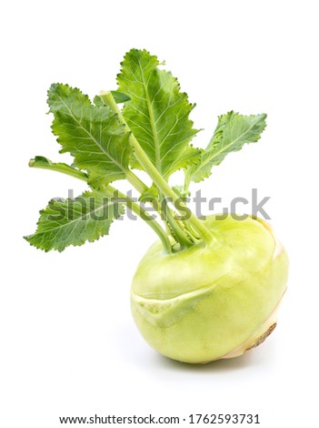 Fresh kohlrabi with green leaves on isolated white background.