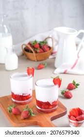 Fresh Korean Strawberry Milk with strawberry compote sauce in the glass with bright white background. Selective focus.