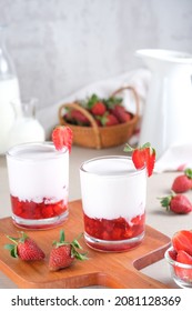 Fresh Korean Strawberry Milk with strawberry compote sauce in the glass with bright white background. Selective focus.