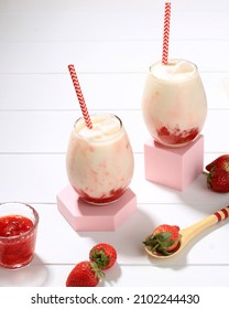 Fresh Korean Strawberry Milk with Strawberry Compote Sauce in Two Glass with Bright White Background Table, Copy Space 