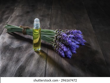 Fresh Lavender Flowers And Essential Oil As Natural Aromatherapy For Headache And Migraine Relief On Old Wooden Background