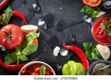 fresh Lecho, ketchup,  with a sprig of green parsley, Basil, tomato slices, red chili pepper, garlic, ice cubes, on a black background, sauce top view, - Powered by Shutterstock