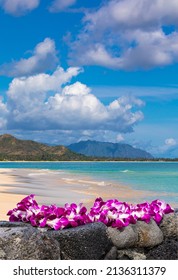 Fresh Lei Flowers Necklace On The Beach, Oahu Hawaiian Island Tropical Vacation Background. Hawaii Luau Icon Travel Concept. Selective Focus.