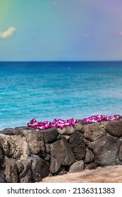 Fresh Lei Flowers Necklace On The Beach, Oahu Hawaiian Island Tropical Vacation Background. Hawaii Luau Icon Travel Concept. Selective Focus.