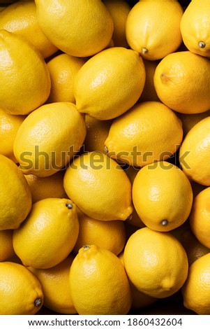 Fresh lemon background. Top view. Citrus fruits. Vitamins for health. Box of yellow lemons. Liposomal vitamin C.