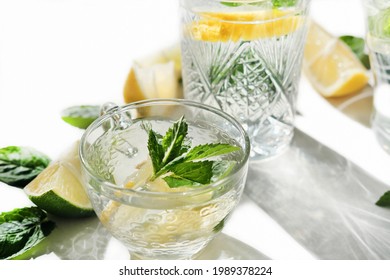 Fresh Lemon And Mint Drink In A Glass Cup. Summer Cold Infused Water For Freshness. Lime And Lemon Slices. Healthy Drinks For Kids Party.