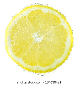 Fresh Lemon In Soda Water Covered With Bubbles On White Background