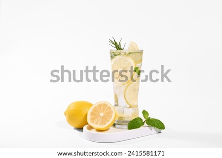 fresh lemon water in glass with lemon slices fruits isolated on white background. cooling beverage summer drink