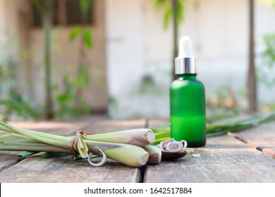 Fresh Lemongrass With Green Bottle On Wood Table In Spa Concept.