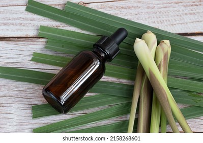 Fresh Lemongrass Leaves With Essential Oil Bottle On Table Lemongrass Is A Tropical, Grassy Plant Used In Cooking And Herbal Medicine. Extracted From The Leaves And Stalks, Citrus Scent.