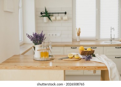 Fresh Lemons, Jar With Honey And Bunch Of Lavender Flowers In A Vase Standing On A Kitchen Table At Home. Ingridients For Making Lemonade. Healthy Food.