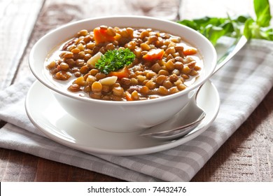 fresh lentil stew in bowl with parsley