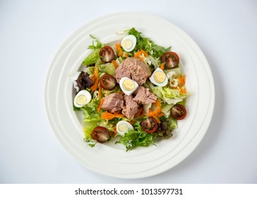 Fresh and Light Tuna Meat Salad with Lettuce, Eggs and Tomatoes Chopped Vegetables Healthy Food for Life on White Table Background Natural Light Selective Focus