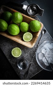 Fresh lime, ice cubes set of cocktail ingredients. ark style, top view. Marble table. Cocktails mixology 