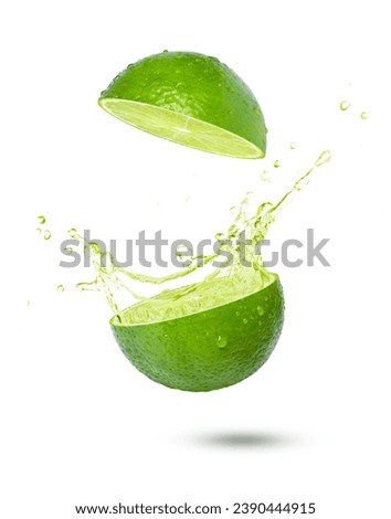 Fresh lime with lime juice splash isolated on white background.