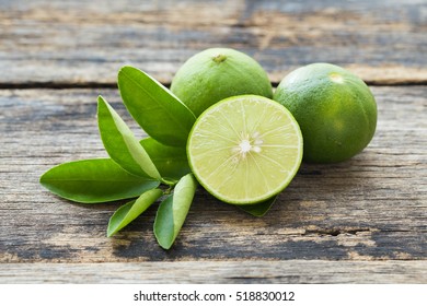 Fresh Limes On Old Wooden Table.