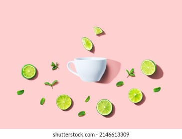 Fresh Limes With Tea Cup Overhead View - Flat Lay