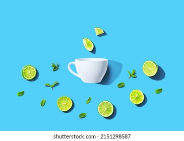 Fresh Limes With Tea Cup Overhead View - Flat Lay