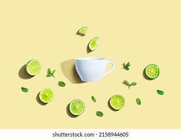 Fresh Limes With Tea Cup Overhead View - Flat Lay