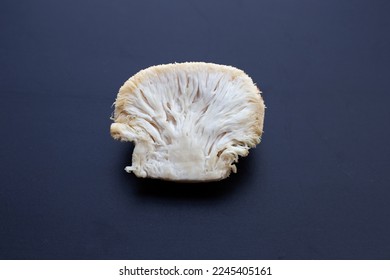 Fresh lion's mane mushroom on dark background.