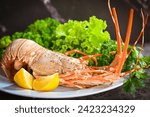 Fresh lobster food on colourfull  background. Top view,red lobster ,lime,slate plate ,red lobster , lemon ,Cooked lobster,wooden board,Canadian Lobster, dinner,Grilled cheese lobster,Boiled 
