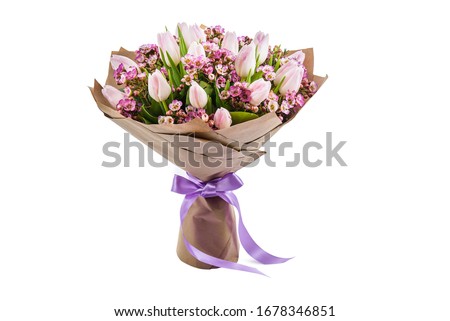 Fresh, lush bouquet of pink roses wrapped in paper for present isolated on white background. Wedding bouquet 
