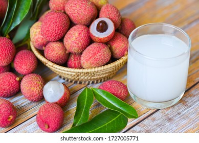 Fresh lychee drink and slice peeled with green leaves harvest in basket from tree tropical fruit summer in Thailand / Lychee juice on wooden table 
