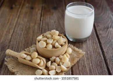 Fresh Macadamia Nut With Glass Of Milk On Wooden Background.