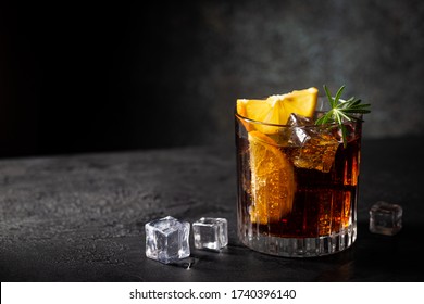 Fresh made Cuba Libre cocktail with brown rum, cola and lemon on wooden background - Shutterstock ID 1740396140