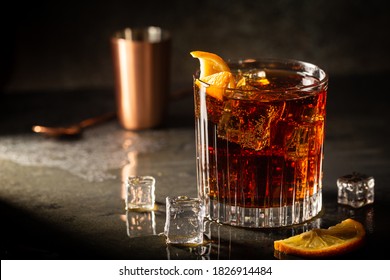 Fresh made Cuba Libre cocktail with brown rum, cola and lemon on wooden background - Shutterstock ID 1826914484