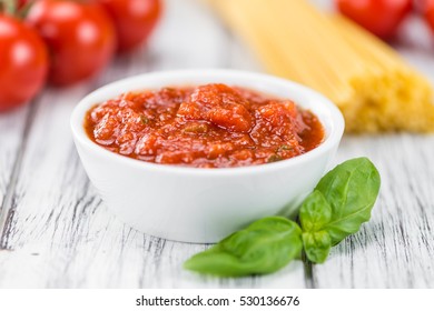 Fresh made Pasta Sauce (Tomato taste) on a vintage background (close-up shot)
