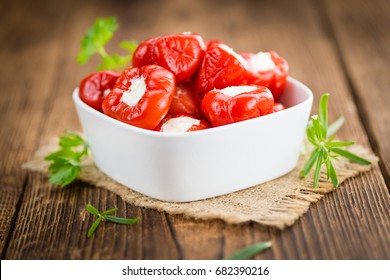 Fresh made Red Pepper (stuffed with cheese) on an old and rustic wooden table (selective focus, close-up shot) - Powered by Shutterstock