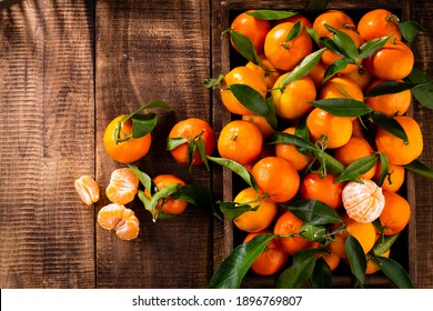 Fresh Mandarin Oranges Fruit With Leaves In Wooden Box, Top View.