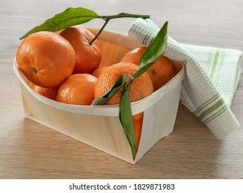 Fresh Mandarins Fruits With Leaves On Wooden Table In Wooden Punett