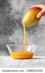 Fresh Mango Juice Pouring Into The Glass Bowl