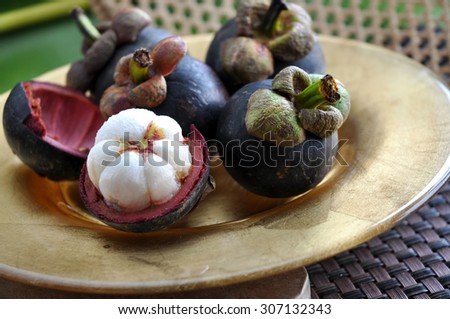 fresh mangosteen fruit on gloden plate