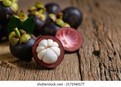 Fresh Mangosteen on old wood baclground. Mangosteen has been known as The Queen of Fruits, asia fruits concept