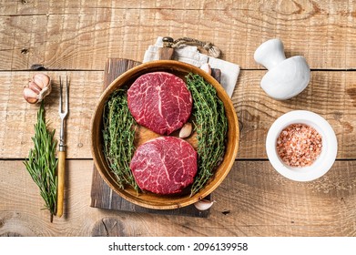 Fresh meat Fillet Mignon steaks from beef tenderloin. wooden background. Top view