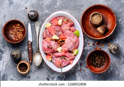 Fresh meat with ingredients for cooking.Raw sliced meat.Citrus marinade.Raw meat slices