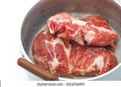 Fresh meat in a pot on white background.