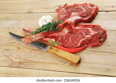 Fresh Meat : Raw Beef Spare Ribs With Thyme , Garlic And Red Chili Pepper Over Wooden Table