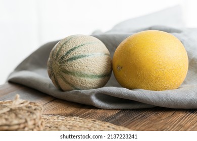fresh melons on tablecloth and rustic table