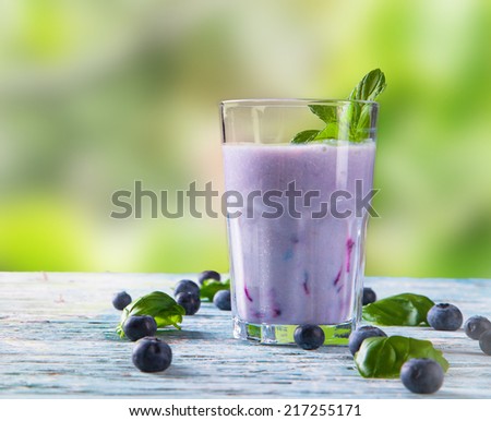Fresh milk, blueberry  drink on wooden table, assorted protein cocktails with fresh fruits.  