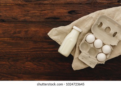 Fresh Milk And Eggs On Wooden Background. Top View 