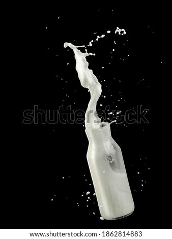 Fresh milk up from a flying bottle and drops