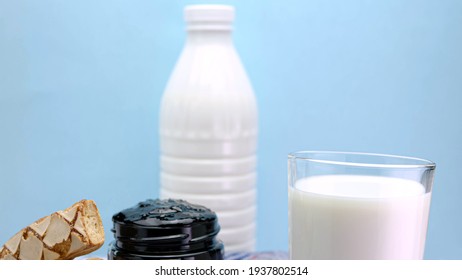 Fresh Milk With Jam And A Snack On A Blue Background.Dairy Products. Milk Is Poured Into A Glass